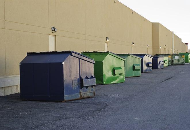 construction dumpsters stacked in a row on a job site in Grand Bay